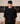 Person wearing black top looking into the camera