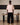 Person wearing black pants and pink standing
